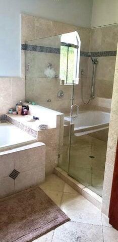 bathroom featuring separate shower and tub and tile patterned flooring