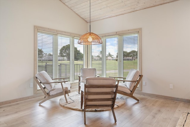 dining area with lofted ceiling, wooden ceiling, light wood-type flooring, and baseboards