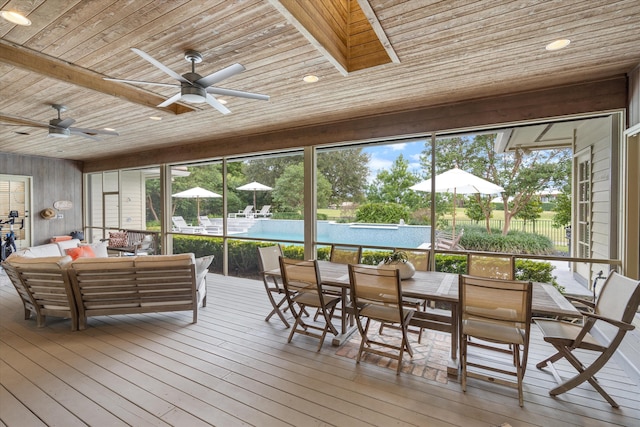 sunroom featuring wood ceiling and ceiling fan