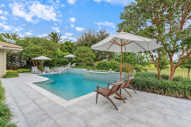 view of swimming pool featuring a fenced in pool, an in ground hot tub, a patio, and fence