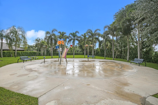 view of community with a yard and community basketball court