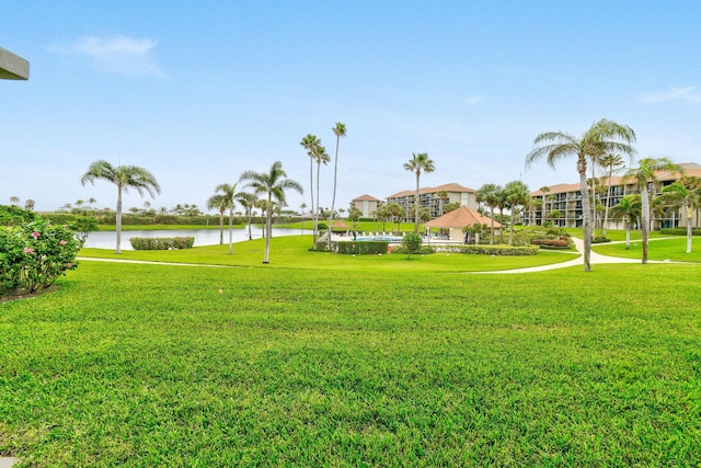 view of community with a water view and a yard