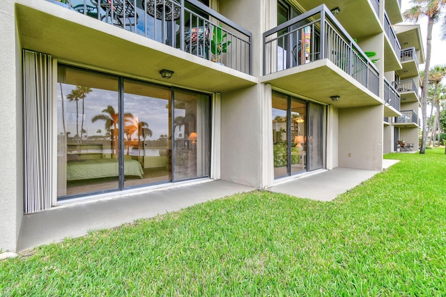 rear view of property with a patio area and a lawn