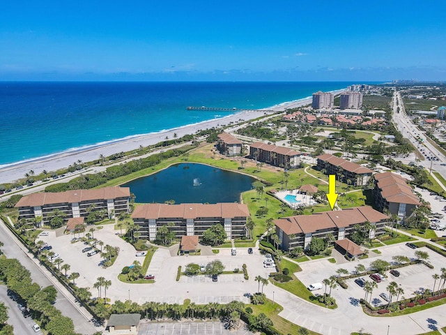 birds eye view of property featuring a water view and a view of the beach