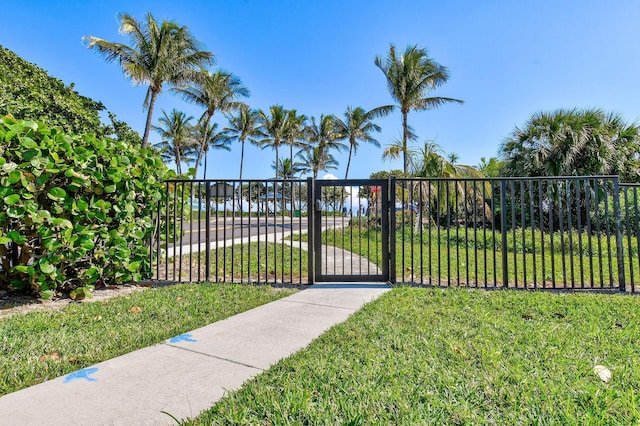 view of gate featuring a lawn and a water view