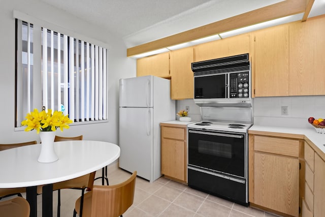 kitchen featuring light brown cabinetry, light tile patterned floors, white refrigerator, electric stove, and decorative backsplash