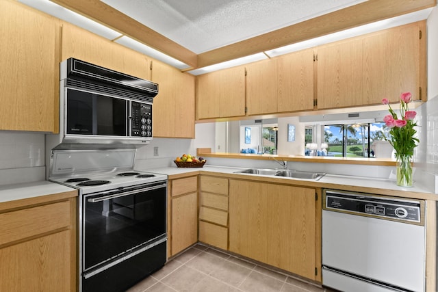 kitchen with sink, light brown cabinetry, white dishwasher, and electric stove