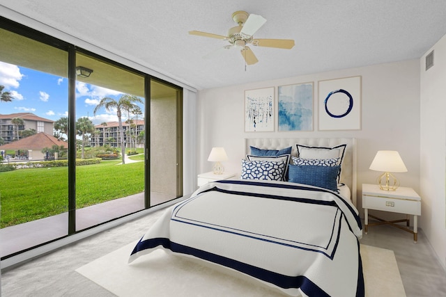 bedroom with floor to ceiling windows, light colored carpet, a textured ceiling, access to outside, and ceiling fan