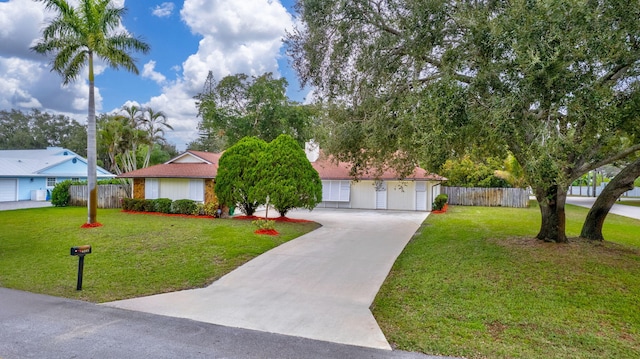 view of front of home featuring a garage and a front yard