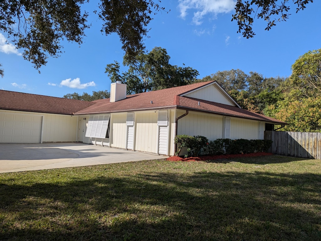 view of side of home with a garage and a yard