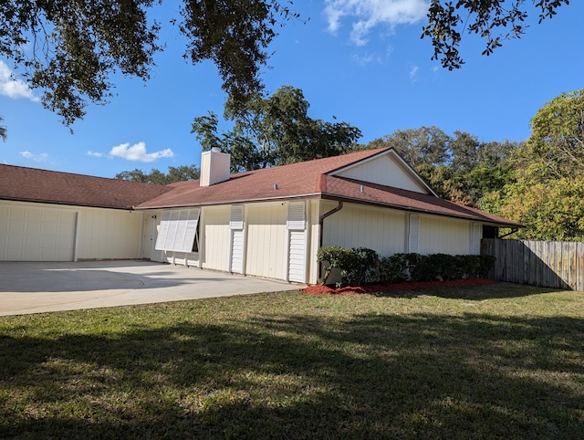 view of side of home with a garage and a yard