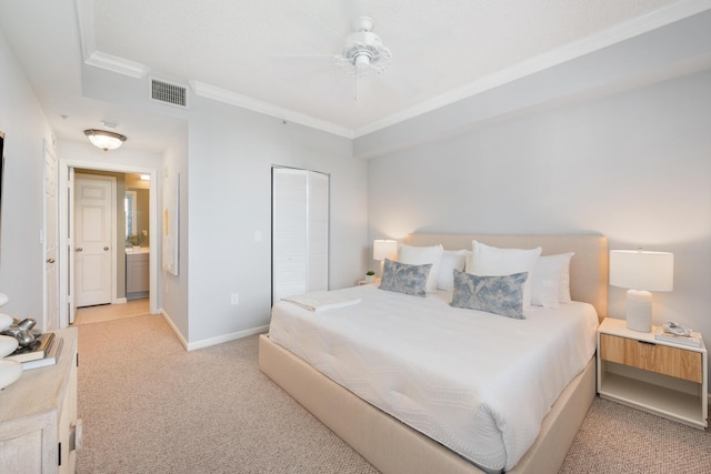 bedroom with light carpet, ceiling fan, connected bathroom, a closet, and crown molding