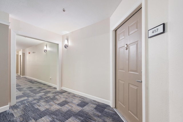 corridor with dark colored carpet