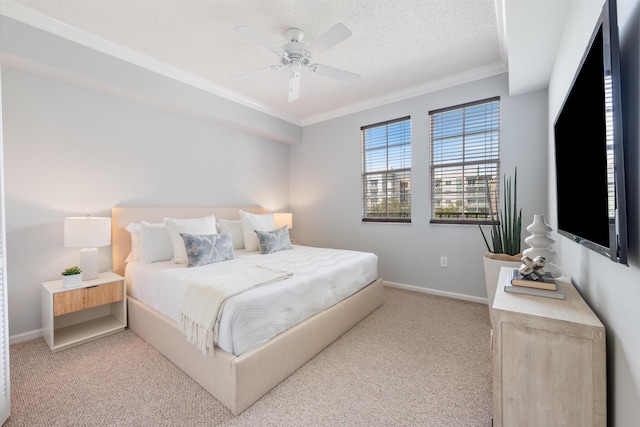 bedroom with a textured ceiling, ceiling fan, ornamental molding, and light colored carpet