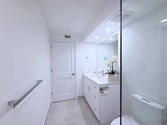 bathroom featuring tile patterned floors, toilet, and vanity