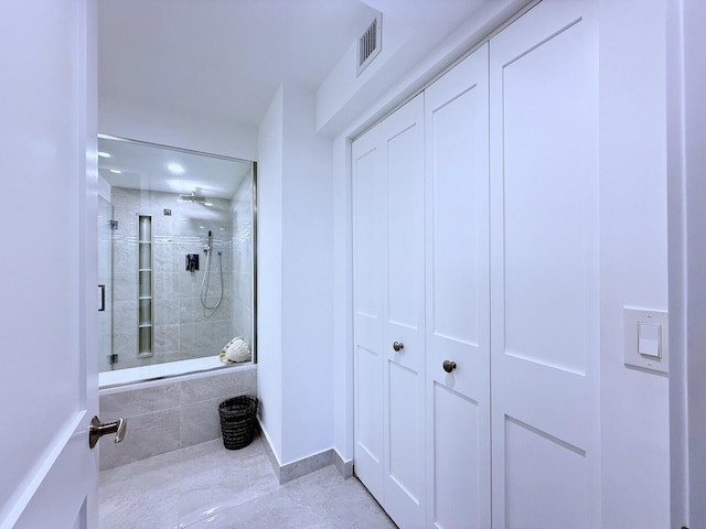 bathroom with a tile shower