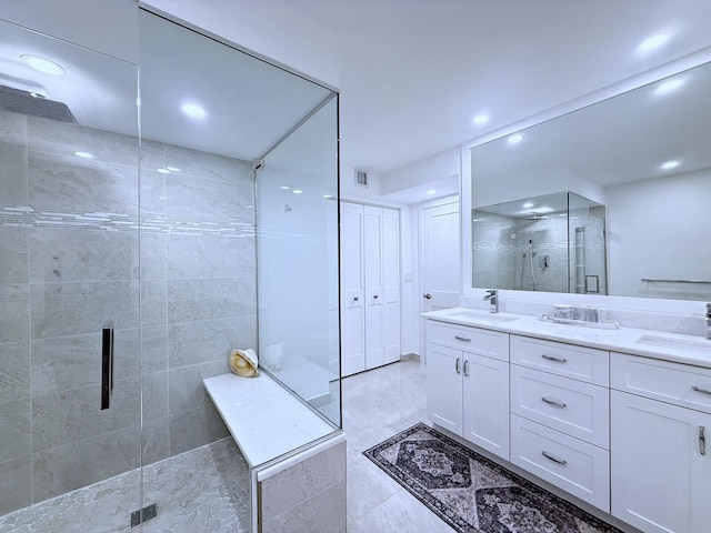 bathroom featuring walk in shower and vanity