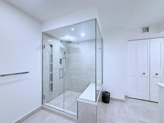 bathroom featuring vanity and a shower with door