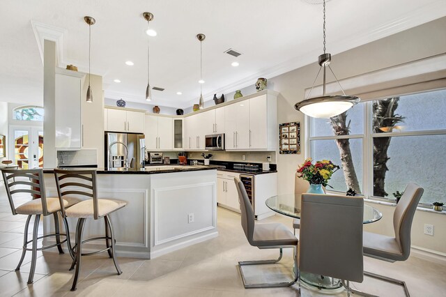 tiled dining room with ornamental molding and ceiling fan