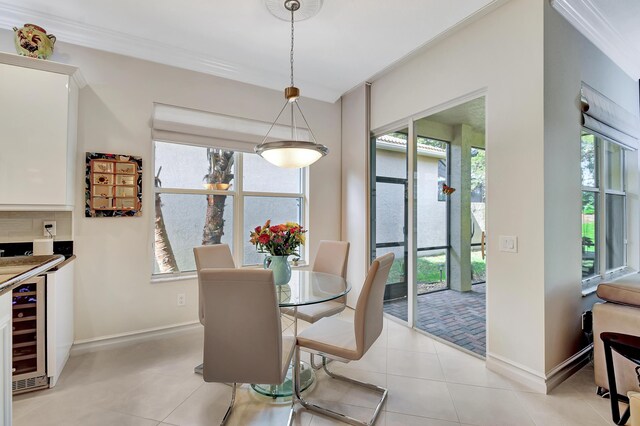 living room featuring light tile patterned floors, ornamental molding, and ceiling fan