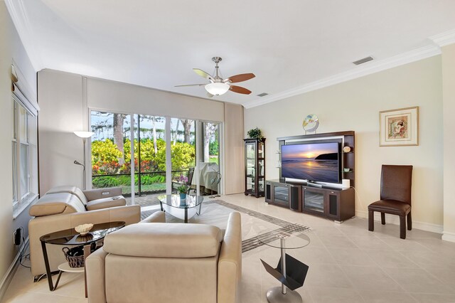 living room featuring ornamental molding, ceiling fan with notable chandelier, and light tile patterned floors