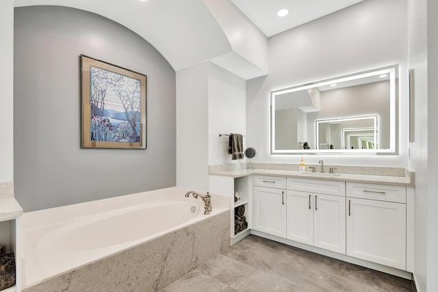 bathroom featuring vanity and a tub