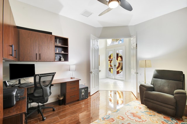 office with hardwood / wood-style flooring, ceiling fan, and french doors