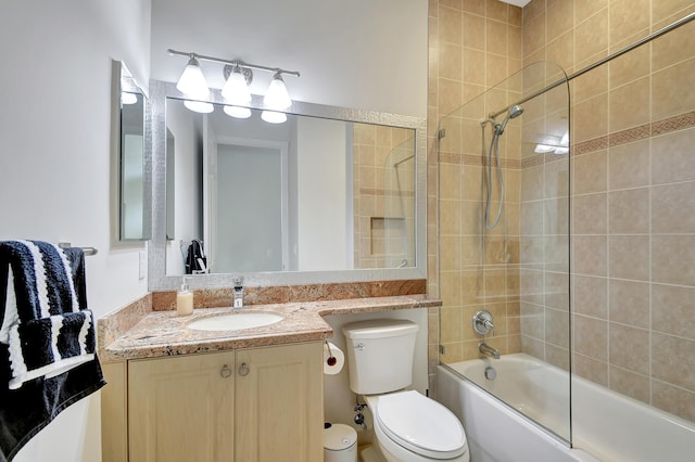 full bathroom featuring vanity, toilet, and tiled shower / bath