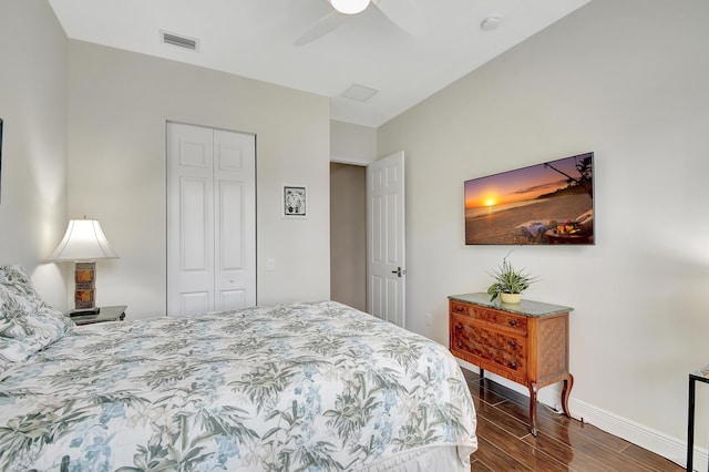 bedroom featuring ceiling fan, dark hardwood / wood-style flooring, and a closet