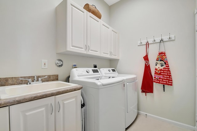 laundry area featuring cabinets, washer and dryer, and sink