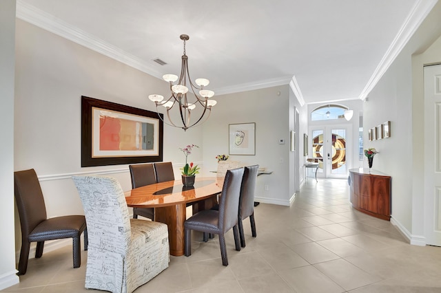 dining area featuring french doors, crown molding, a chandelier, and light tile patterned floors