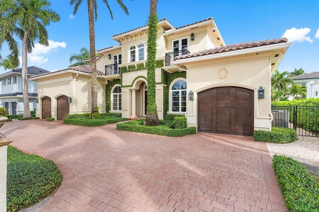 mediterranean / spanish home with a balcony and a garage