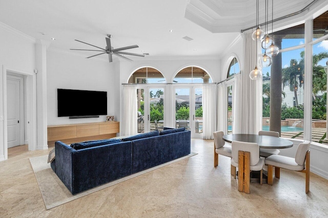 living room featuring ceiling fan, plenty of natural light, crown molding, and french doors