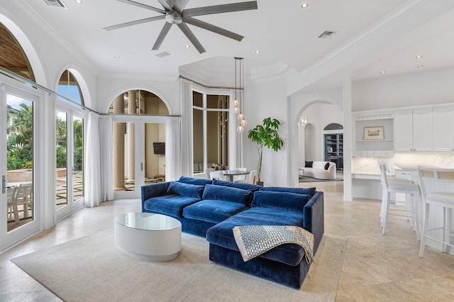 living room with ceiling fan and crown molding