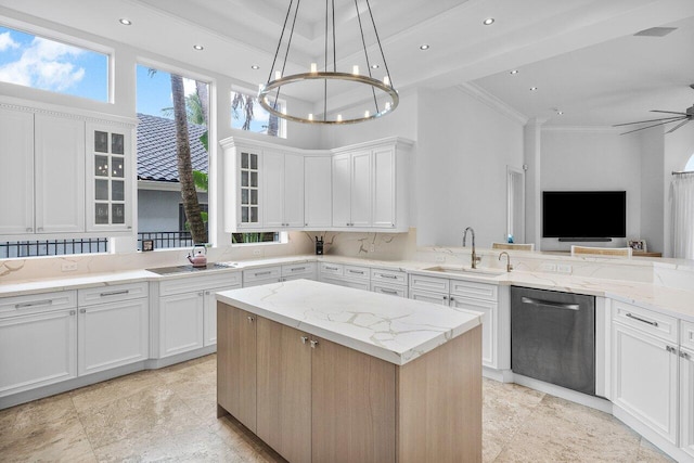 kitchen with dishwashing machine, a towering ceiling, sink, and white cabinetry