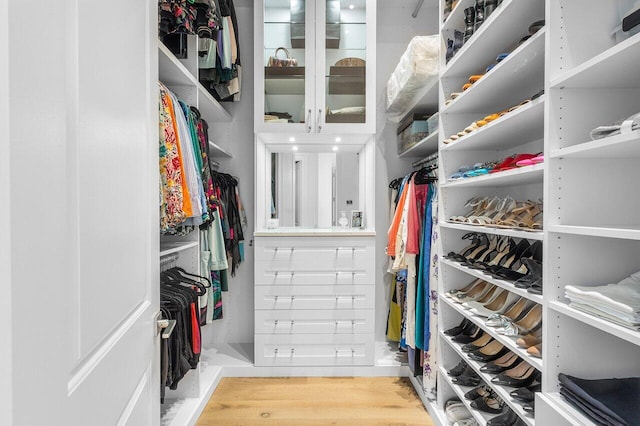 walk in closet featuring light hardwood / wood-style flooring