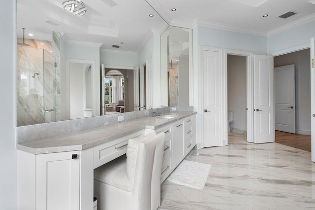 bathroom featuring an enclosed shower, vanity, crown molding, and toilet