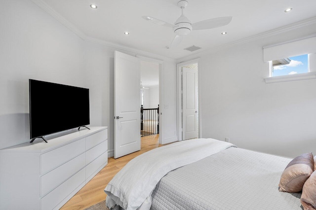 bedroom featuring ceiling fan, light hardwood / wood-style flooring, and crown molding