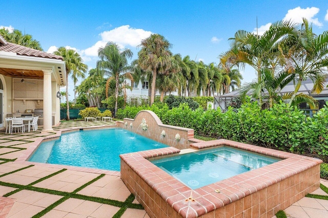 view of pool with pool water feature, a patio area, and an in ground hot tub