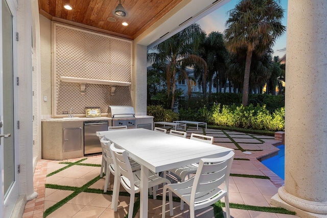 view of patio / terrace featuring an outdoor kitchen, sink, and a grill