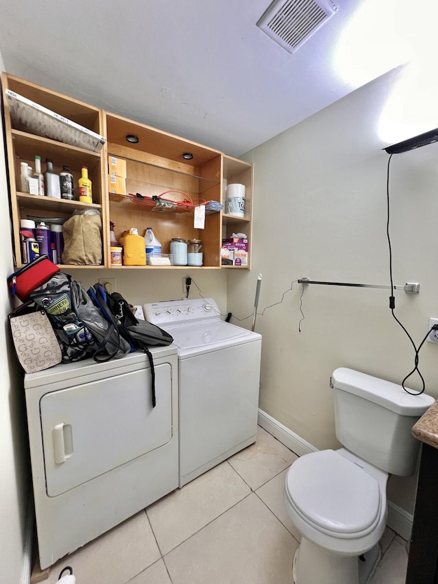 bathroom featuring toilet, tile patterned flooring, and independent washer and dryer