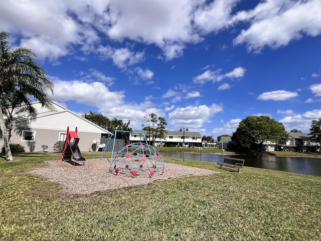 view of jungle gym with a yard and a water view