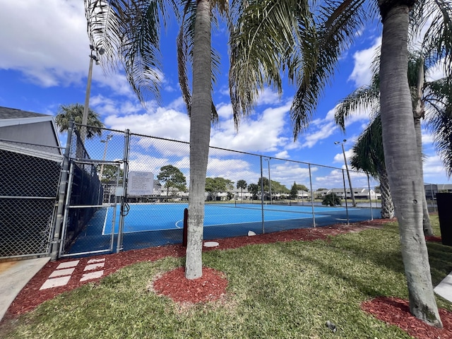 view of sport court featuring a yard