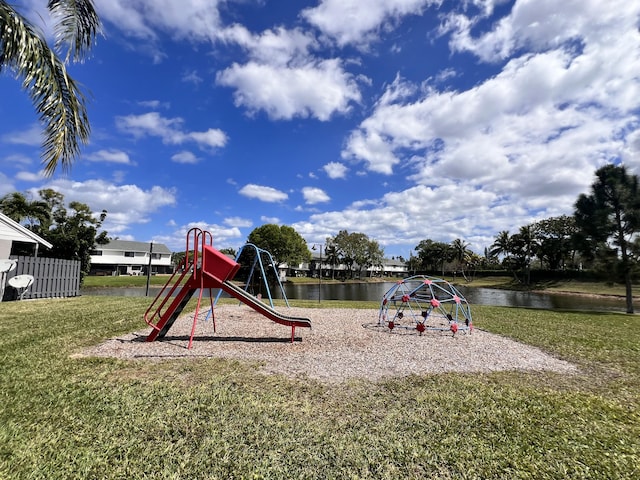 view of playground featuring a water view and a lawn