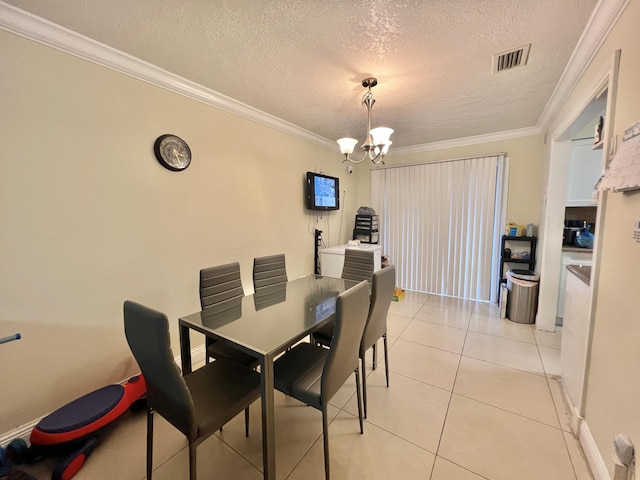 tiled dining area featuring an inviting chandelier, ornamental molding, and a textured ceiling