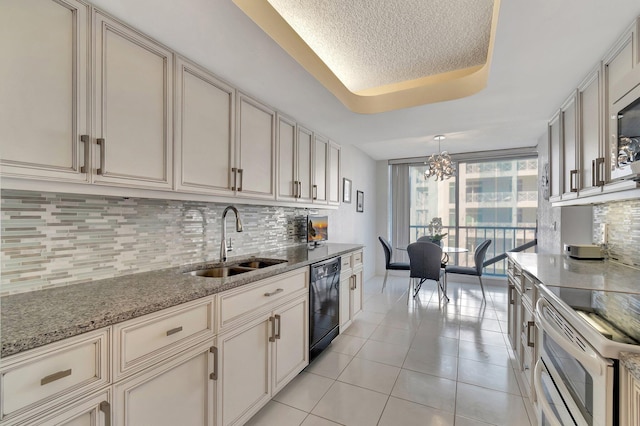 kitchen with tasteful backsplash, dishwasher, a raised ceiling, and sink