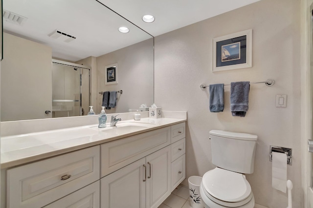 bathroom with walk in shower, vanity, toilet, and tile patterned flooring