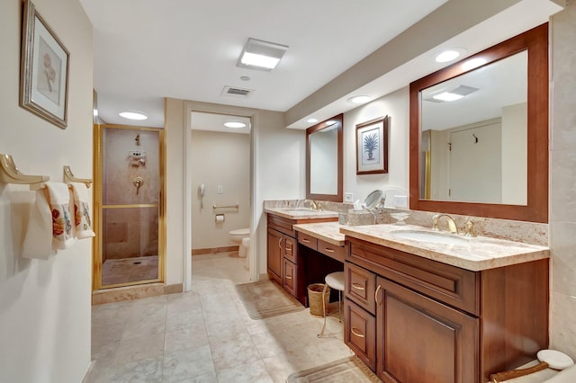 bathroom featuring an enclosed shower, vanity, and toilet