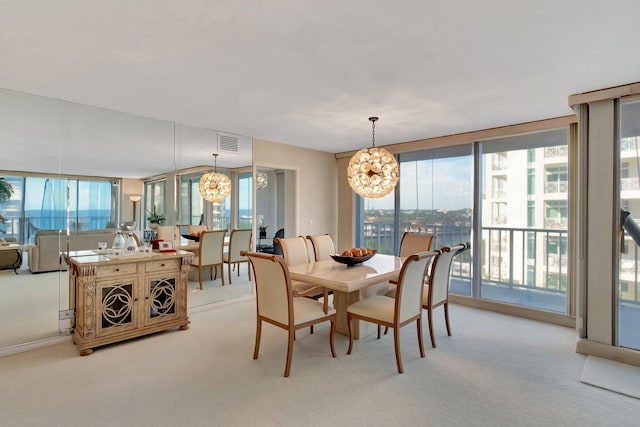 dining room with floor to ceiling windows, a healthy amount of sunlight, light colored carpet, and a chandelier