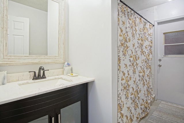 bathroom with vanity and a textured ceiling